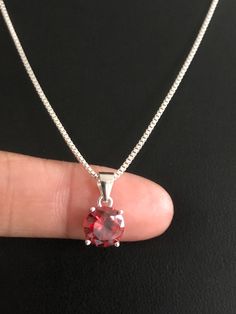 "Sterling Silver Garnet Necklace, Garnet Cubic Zirconia Pendant Necklace NECKLACE FEATURES: Metal: All components are made from solid .925 Sterling Silver Model is wearing 16\" in length solid .925 Sterling Silver Chain Length available: 16\", 18\" or 20\" Stone: Garnet CZ THE Garnet CZ pendant measures 8mm in height Your Garnet Necklace will arrive in a gift box, beautifully wrapped and ready for gifting Please send me a convo if you have any questions before placing your order. Please also vie Garnet Necklace, Cz Pendant, Garnet Stone, 925 Sterling Silver Chain, Stone Pendants, Sterling Silver Chains, Cubic Zirconia, Garnet, Silver Chain