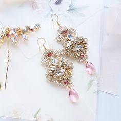 Chandelier statement wedding earrings. Hand embroidered with rhinestone on Venice lace, topped with lovely crystals. Earrings are very light and comfortable to wear, you can order matching bracelet and hair pins (separately). You can as well order earrings in other rhinestone crystals. This earrings will be shipped nicely packed in the gift box. For other wedding jewelry visit my shop; https://www.etsy.com/shop/byPiLLowDesign Gold Chandelier Earrings With Crystals For Wedding, Gold Crystal Chandelier Earrings For Wedding, Gold Crystal Wedding Earrings, Gold Bling Crystal Earrings For Wedding, Crystal Embellished Bridal Drop Earrings, Crystal Embellished Bridal Drop Earrings For Wedding, Gold Crystal Earrings For Wedding, Wedding Crystal Embellished Chandelier Drop Earrings, Elegant Jeweled Crystal Earrings For Wedding