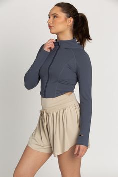 The perfect throw-on-and-go jacket is our Storm Athletic Hoodie Jacket. This piece features a classic hoodie style with thumb-hole finished sleeves. The material is a soft, stretch fabric that controls temperature and provides a cool, sporty look. Athletic Hoodie, Hoodie Style, Tennis Skirts, Athletic Top, Yoga Tops, Sporty Look, Athletic Shorts, Hoodie Jacket, Model Height