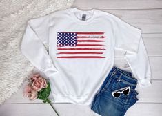 "USA Flag Sweatshirt, Patriotic Sweatshirt, 4th Of July Gifts, American Flag Sweatshirt Men Women, USA Crewneck Sweatshirt, Memorial Day Gift Need custom made sweatshirts?  Here is a high quality, super soft and cozy sweatshirt with a comfortable feel for you and your loved ones. You will love wearing it for a casual and relaxed fit. And anyone would look so lovely rocking it ❤︎ All of the brands we use are high quality, we never substitute quality. Thanks for supporting our small business and e Relaxed Fit Graphic Print Sweatshirt For 4th Of July, Patriotic Letter Print Sweatshirt For Independence Day, White Crew Neck Sweatshirt For 4th Of July, White Long Sleeve Tops For Independence Day, Patriotic White Cotton Sweatshirt, Independence Day Crew Neck Sweatshirt With Letter Print, Casual Letter Print Sweatshirt For Independence Day, Independence Day Letter Print Crew Neck Sweatshirt, Independence Day Casual Letter Print Sweatshirt