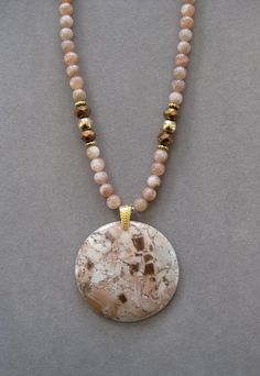 This is a beautiful round Tan and Beige Crazy Lace Agate Pendant Necklace. These stones are very rare and hard to find. It is 16 inches long and adjustable to 21 inches with a lobster clasp and chain. The pendant measures 1 3/4 inches round. The beads in the chain are Beige Moonstone and match the pendant stone.  My prices have gone up due to ETSY raising Fees and it's hard to find nice pendants and their prices have gone up a lot All my jewelry is unique and one of a kind. Similar quality jewel Agate Pendant Necklace, Dragon Vein Agate, Moonstone Beads, Crazy Lace Agate, Shell Pendant, Agate Pendant, Lace Agate, It's Hard, Stone Pendants