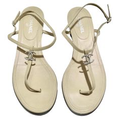 Introducing the timeless elegance of Chanel CC T Strap Leather Sandals, a classic and versatile addition to your footwear collection. Crafted from luxurious beige leather, these strappy sandals feature a T-strap style design that exudes sophistication and style. At the center of the T-strap, a silver-tone interlocking CC logo adds a touch of iconic Chanel charm, elevating the sandals with a subtle yet recognizable detail. The buckle closure on the side ensures a secure and adjustable fit, provid Chanel Charm, Cocktail Dress Outfit, Sandals Vintage, Pucci Dress, Saint Laurent Handbags, Footwear Collection, Gucci Handbags, Cc Logo, Vintage Store