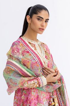 This short, aurora pink angarkha is the embodiment of a classy yet charming festive look. It is rendered with a thoughtful arrangement of zardoze and gota work on a floral-printed khaddi silk, featuring a chatapatti border. A multi-coloured dupatta with gota finishing and a printed shalwar add the final touches to this Transitional Pink Churidar With Sheer Dupatta, Pink Anarkali Set With Cutdana In Chinon, Transitional Season Pink Salwar Kameez With Cutdana, Pink Chinon Anarkali Set With Cutdana, Anarkali Dupatta With Gota Work For Designer Wear, Transitional Multicolor Kurta With Sheer Dupatta, Festive Pink Cutdana Churidar, Pink Kurta With Gota Work And Traditional Drape, Bollywood Style Pink Cutdana Kurta