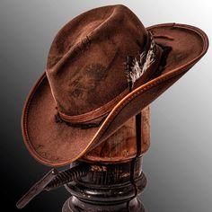 Description -Felt Wool Material -Brim 3 1/2" -Crown 4 3/4" -Cowhide Leather Hat Band -Leather Accents -Hand Distressed Finish The Duke Brown is the hat I'd choose if I were to fight a grizzly bear. This felt cowboy hat is hand distressed to give it a rugged textured look that you just can't find with other competitors. This hat looks and feels like a valuable heirloom while having the quality to last as long as any family heirloom. With a rugged pioneer look like this even Davy Crockett would en Cool Cowboy Hats, Cowbow Hat, Brown Cowgirl Hat, Cow Boy Hat, Best Cowboy Hats, Girls Hair Style, Cowboy Clothes, Cowboy Accessories, Cowboy Fashion