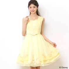 a woman in a yellow dress posing for the camera with her hand on her hip