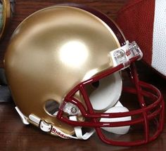 a football helmet sitting on top of a wooden table