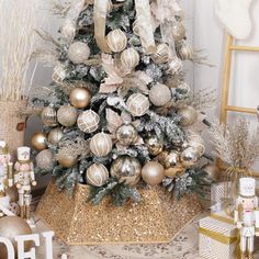 a decorated christmas tree with gold and silver ornaments