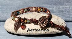 Passage Leather Wrap Bracelet by Aerieanna Made with 100% USA naturally dyed leather in dark brown and an assortment of gemstone beads that can include African Turquoise, Lapis Lazuli, Red Jasper, Clear Quartz, Rose Quartz, Landscape Jasper, Unikite, Carnelian, Mookite, Sodalite, Amethyst with two Czech fire-polished crystals. Wire wrapped beady dangles. Closes with a copper shell button at 7.5 or 8.5". Not your size? Request a custom order! Brown Leather Beaded Bracelets For Festival, Hippie Brown Round Bead Bracelets, Bohemian Brown Wire Wrapped Beaded Bracelets, Bohemian Beaded Leather Wrap Bracelet, Bohemian Leather Wrap Bracelet Adjustable, Bohemian Leather Wrap Bracelet, Adjustable, Bohemian Leather Wrap Bracelet As Gift, Bohemian Leather Wrap Bracelet Gift, Bohemian Hand Wrapped Brown Bracelets