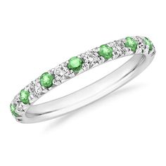 a wedding band with green and white stones