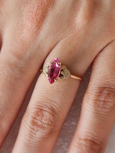 Pink Tourmaline ring.  Marquise shaped Tourmaline in 10 carat yellow gold with stylised sides pave with 6 diamonds.  The Tourmaline weighs 1.04ct and very nice pink hue. Ring size is N (Australian size) or 6 1/2 (US size). Ring is ready to ship in 2-3 working days.  We resize free of charge.  Please allow a couple of additional days for resizing. All my rings come in a velvet ring box.  I am highly conscious of environmental damage that extra packaging can create so my pieces come in appropriate jewellery box with no extra packaging. This ring has free standard shipping offer from Australia.  If you need a quicker postal service, please proceed to buy an Express post shipping listing and I will post accordingly. https://www.etsy.com/your/shops/me/listing-editor/edit/930123172#about Pink Diamond Gold Ring, Rings Pink, Diamond Gold Ring, Velvet Ring, Velvet Ring Box, Pink Tourmaline Ring, Ring Marquise, Environmental Damage, Tourmaline Ring