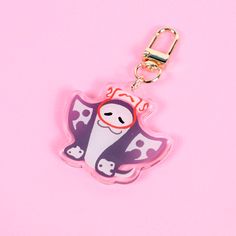 a pink keychain with a cartoon dog on it