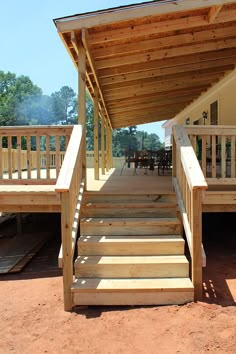 wooden steps leading up to a covered patio