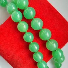 Thank you for visiting the SoChicFinds store - vintage and antique, costume and fine jewelry.  Knotted green stone bead necklace.  Gemstone: emerald green chalcedony - Graduated beads from 10mm to 14mm.  Length of the natural stone necklace: 56 cm ~ 22 inch. Weight of the heavy chalcedony necklace: 99,3 grams. Vintage necklace - 1950s jewelry. Knotted Green Chalcedony Bead Necklace 22 inch, Graduated Natural Stone Beads, Vintage Gemstone 1950s Chunky Jewelry for Women. Vintage Jewelry With Round Gemstone Beads, Vintage Round Gemstone Beads Jewelry, Vintage 8mm Beads Jewelry For Formal Occasions, Vintage Formal Beaded Necklace With Polished Beads, Vintage Formal Jewelry With 8mm Beads, Vintage Beaded Necklaces For Formal Occasions, Vintage Formal Beaded Necklaces With Polished Beads, Formal Vintage Jewelry With 8mm Beads, Vintage Round Beaded Necklaces For Formal Occasions