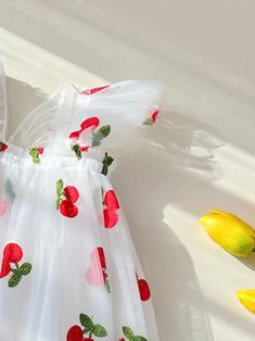 Frolic through the day in this delightful cherry-embellished flower girl dress. The airy tulle skirt is sprinkled with a cheerful pattern of red fruit and greenery, invoking the playful spirit of a sunny orchard. With its flutter sleeves and an oversized back bow, this dress is perfect for a little one who loves to play dress-up for real-life special occasions. US Length Bust size 9-12M 18.5 20.1 1-2Y 19.3 20.9 3-4Y 20.5 22.1 4-5Y 21.7 23.2 5-6Y 22.9 24.0 Sweet Sleeveless Summer Princess Dress, Spring Floral Applique Princess Dress For Garden Party, Whimsical Summer Dress With Tulle Skirt, Whimsical Summer Tulle Dress, Sweet Princess Dress For Spring Garden Party, Sweet Sleeveless Princess Dress For Spring, Sweet Summer Dresses With Floral Applique, Summer Floral Print Tulle Dresses, Playful White Sleeveless Princess Dress