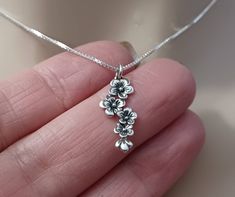 She is sure to love this adorable - SMALL, delicate - 925 Sterling Silver Cascading Cherry Blossom Flower Charm Pendant (23mm). Featuring an oxidized, textured finish for a dramatic look. Its full, unfolding petals suggest the expansion of the soul.  Comes with a well made 925 Sterling Silver .8mm Cable or Box Chain and choice of Necklace Gift box. This Necklace will make the perfect  Gift. Great for everyday wear! Click on Link below to Shop our Etsy Store: www.etsy.com/shop/LastingMemoryJewelr Snowdrop Flower Necklace, Flower Necklace Silver, Dainty Silver Necklaces, Silver Flower Jewelry, Silver Necklace Pendant, Vintage Silver Necklaces, Silver Dainty Jewelry, Dainty Flower Necklace, Vintage Silver Necklace