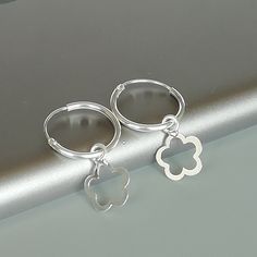 A PAIR of sterling silver hoops. Comes with a detachable cut out flower charm. The charm is multipurpose and can be used with a neck or bracelet chain too. Dimension: Hoop- 15 x 1.5 mm Charm: 10 x 12 mm Drop length- 23 mm These earrings are made of 925 hypoallergenic sterling silver and plastic. Please note this price is for ONE PAIR. All my pieces are sent in a gift box. I can include a personal message from you if needed You are welcome to contact me at... bhavnakwintra1956@gmail.com For more Gift Huggie Hoop Earrings With Flower Charm, Small Hoop Earrings With Flower Charm As Gift, Silver Huggie Earrings With Charms, Hoop Earrings With Flower Charm As Gift, Silver Charm Hoop Earrings, Gift Hoop Earrings With Flower Charm, Silver Dangle Hoop Earrings With Charms, Silver Earrings With Flower Charm For Everyday, Everyday Silver Earrings With Flower Charm