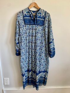 "Vintage 1970s Indian cotton block print bohemian maxi dress / peasant dress / kaftan. Shades of blue (cobalt, turquoise and navy) with black & gold accents on a white background. No tag or size but could fit a size XS with room up to a size Medium depending on one's body. Dress measures 20\" across the chest from armpit to armpit and 45\" long. Pleated / bib front with small ties from v-neckline. Generously cut from shoulder to bottom hem. Billowy sleeves with elastic cuffs. A stunning, one of Bohemian Printed Tunic Maxi Dress, Bohemian Block Print Tunic Maxi Dress, Bohemian Flowy Block Print Dresses, Flowy Bohemian Block Print Dresses, Blue Bohemian Maxi Dress, Bohemian Tunic Dress In Patterned Color, Patterned Bohemian Tunic Dress, Bohemian Block Print Maxi Dress For Festival, Bohemian Patterned Tunic Dress