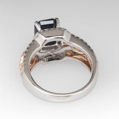 This gorgeous 18K white and rose gold ring is centered with one (1) emerald cut natural sapphire weighing 2.71 carats that is set into a four-prong setting. The top half of the ring is accented with one hundred two (102), prong set, round brilliant cut diamonds. The ring measures 12.0mm at the top, rises 9.5mm above the finger, tapering to 3.1mm wide and 1.3mm thick at the base of the shank. It is currently a size 5.75. Elegant Gia Certified Emerald Cut Sapphire Ring, Luxury Emerald Cut Sapphire Ring With Diamond Detail, Gia Certified Square Cut Sapphire Ring, Elegant Gia Certified Square Cut Sapphire Ring, Luxury Square Cut Sapphire Ring With Prong Setting, Luxury Sapphire Ring With Emerald Cut And Accent Stones, Emerald-cut Sapphire Ring In Rose Gold With Accent Stones, Emerald-cut Rose Gold Sapphire Ring With Accent Stones, Rose Gold Emerald-cut Sapphire Ring With Accent Stones