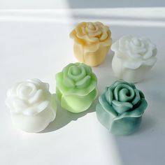 four small soap flowers sitting next to each other