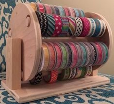 a wooden holder with many different colored ribbons