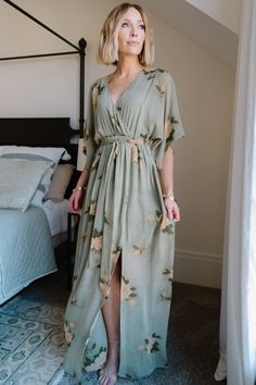 Our Kia Kimono Maxi Dress is perfect for any occasion! It features an olive and marigold floral print. This dress is great for maternity! Spring Dresses With Kimono Sleeves, Spring Flowy Dresses With Kimono Sleeves, Spring Dresses With Flowy Kimono Sleeves, Flowy Spring Dresses With Kimono Sleeves, Spring Dresses With Flowy Fit And Kimono Sleeves, Flowy Dress With Kimono Sleeves For Brunch, Green Kimono Sleeve Dress For Spring, Green Wrap Dress For Spring Garden Party, Green Maxi Dress With Floral Print And Kimono Sleeves