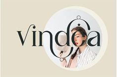 a woman with long hair is holding a fan in her hand and the word vindea on it