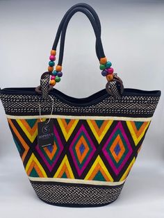 These beautiful handbags are made from Cana Flecha which is an indigenous palm fiber found in the northern territory of Colombia. They are beautifully hand crafted by the people from the Zenu tribes in Colombia. These handbags are colorful with vibrant colors, which is a pure reflection on the region and the warmness of these master artisans that work in this industry every day. Traditional Rectangular Vacation Bag, Traditional Rectangular Vacation Bags, Traditional Satchel Bag For Beach, Multicolor Bohemian Straw Bag With Double Handle, Traditional Satchel Beach Bag, Traditional Tote Beach Bag For Travel, Traditional Black Rectangular Crochet Bag, Traditional Black Woven Crochet Bag, Traditional Black Crochet Woven Bag