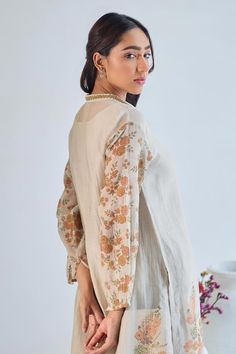 Grey full sleeves A-line kurta crafted in mul chanderi with floral handblock print, front inverted pleat and embroidered work on the V neckline. Paired with a pant and an inner. - Aza Fashions Long Sleeve Kurta With Yoke For Eid, Eid Long Sleeve Kurta With Yoke Detail, Eid Kurta With Yoke Detail And Long Sleeves, Traditional Long Sleeve Blouse With Printed Motifs, Cotton Silk Kurta With Embroidered Sleeves, Cotton Anarkali Top With Long Sleeves, Cotton Palazzo Set With Long Sleeves For Designer Wear, Long Sleeve Cotton Silk Kurta With Embroidered Sleeves, Cotton Palazzo Set For Designer Wear