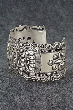 This stunning and intricate sterling silver bracelet was made by Navajo silversmith Eugene Charley. The inside is signed and stamped sterling.Size: 6" (will fit up to a 7 3/8" wrist)Gap: 1 3/8"Width: 1 1/2"Free shipping on all orders! We ship with USPS and always include tracking. All orders ship within a day of payment.Returns are accepted up to 30 days after you receive your order. Just send us a message. Our shop offers cash back or store credit. The item must be returned in new condition. Intricate Silver Sterling Bracelets, Sterling Silver Bracelet With Intricate Design Adjustable, Sterling Silver Bracelets With Intricate Design, Silver Sterling Silver Bracelet With Intricate Design, Ornate Sterling Silver Bangle Jewelry, Unique Silver Jewelry With Intricate Design, Traditional Nickel-free Sterling Silver Bracelet, Traditional Sterling Silver Nickel-free Bracelet, Adjustable Ornate Sterling Silver Bangle