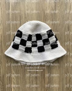 a crocheted hat with black and white squares