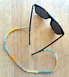 "Wood, vintage glass beaded croakie, custom made in Denver, CO. 24\" is the total length.  Stretchy cord provides a comfortable wear. Boho Chic Sunglasses Chain over 40 styles! - Adjustable Rubber Holders to keep cord in place and glasses secure! - Easy attachment, fits ALL glasses! - Perfect for Sunglasses or Reading Glasses - Stylish, comfortable and cool! Perfect for everyday activities or just looking fly in your daily routine or out and about on the scene!" Adjustable Glass Beaded Necklaces With Tiny Beads, Adjustable Glass Beaded Necklace With Tiny Beads, Adjustable Tiny Beaded Glass Necklaces, Adjustable Tiny Beaded Glass Necklace, Adjustable Glass Necklaces With Tiny Beads, Adjustable Glass Necklace With Tiny Beads, Adjustable Yellow Single Strand Beaded Necklaces, Adjustable Yellow Single Strand Beaded Necklace, Adjustable Single Strand Yellow Beaded Necklaces