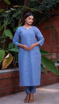 Comfortable kurta made in pure linen fabric with hand embroidered tikkis. Matching straight narrow pants. An absolute all-season essential - cool in summer and warm in winter. Features a round V neck. Quarter sleeves. Fully lined kurta. Kurta Fabric : Linen. Pants Fabric : Cotton Linen. Model height is 5.3” and is wearing a size M. Wash Care : Dry Clean Only. Linen Sets With Chikankari Embroidery In Straight Kurta Style, Spring Linen Straight Kurta Set, Festive Blue Pants With Chikankari Embroidery, Linen Straight Kurta With Resham Embroidery, Linen Kurta With Resham Embroidery, Straight Linen Kurta With Resham Embroidery, Linen Sets With Chikankari Embroidery For Summer, Festive Embroidered Linen Kurta, Summer Linen Set With Chikankari Embroidery