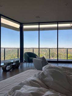 a bedroom with large windows and a view