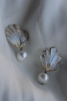 - The stunning floral adornment earrings features handcrafted dip art UV resin seashell elements  - The dangle drop earrings feature light and textured cotton pearls;  - Looks so realistic and absolutely fantastic live; -  A very light and sturdy construction;  - SIZE:  - Available in silver and gold hardware; - Rhodium-plated hypoallergenic posts; With love, Anastasia Enze Bridal Jewelry Elegant Shell Dangle Earrings, Elegant Dangle Shell Earrings, Elegant Shell-shaped Clip-on Earrings For Gift, Elegant Dangle Shell, Elegant Pearl Charm Earrings With Shell, Unique Pearl Drop Earrings For Wedding, Unique Wedding Pearl Drop Earrings, Elegant Shell Drop Earrings, Gold Shell-shaped Earrings For Wedding