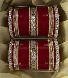 two red and gold bangles sitting on top of each other