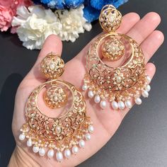 Featuring a pair of beautifully carved chandbali earrings embellished with freshwater pearls. The earrings have a clip at the back and bombay screw. A timeless addition to your collection, these earrings are as gorgeous to behold as they are to wear. Their pure sophistication and bold elegance will elevate your look. Luxury Bollywood Chandbalis With Hand Set Details, Luxury Heavy Chandbalis For Festive Season, Luxury Bollywood Style Round Earrings, Cheap Wedding Chandbalis, Cheap Bollywood Style Festive Danglers, Luxury Chandbali Jewelry Sets With Tilla, Handmade Luxury Chandbali Jewelry Sets, Luxury Meenakari Chandelier Earrings For Wedding, Luxury Bridal Chandbali Earrings With Intricate Design