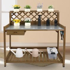 a potting bench with flowers and watering tools