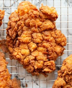 some fried food is on a cooling rack and ready to be eaten by someone else