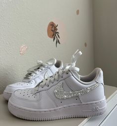 These beautiful embellished pearl Nike Air Force 1 are perfect to walk down the aisle in. They are also perfect for every day occasions to bring a little flare to your outfit. Item Details -Shoes are a White Nike Air Force 1 -You can find the size chart on the Nike website -Embellished with high quality decorative pearls -Super strong industrial jewelry glue is used to ensure that the pearls adhere -Only the check marks will be covered in pearls Nike Air Force Wedding Shoes, Elegant Wedding Sneakers With Rhinestones, Elegant Embellished Sneakers For Wedding, Elegant Embellished White Sneakers, Elegant White Embellished Sneakers, Air Force Custom, Bridal Air Force 1, Pearl Nike Air Force, Wedding White Embellished Sneakers