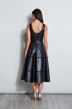 Meet our modern, endlessly versatile Fit & Flare Dress in luxe Vegan Leather that's infused with a chic vibe. The feminine self-belt & tiered midi skirt give it the cool factor whether worn with pumps or dressed up with strappy heels for night. Vegan Leather Belted Midi Fit & Flare Dress 100% Polyester Runs true to Size Model is 5'9" and wearing size 2 Dry Clean Only Imported Style #: ETR44228 Tiered Midi Skirt, Tahari Dress, Long Sleeve Short Dress, Knit Tees, Denim Coat, Leather Dress, Knit Jacket, Dress 100, Skirts For Sale