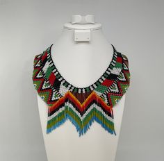 This beautiful beaded necklace is hand-woven by the women of the Embera Chami Indigenous Tribe of Colombia Traditional Multicolor Jewelry With Beaded Fringe, Traditional Multicolor Beaded Fringe Necklaces, Traditional Multicolor Beaded Necklaces With Fringe, Traditional Beaded Fringe Necklace, Traditional Beaded Fringe Necklace As Gift, Traditional Multicolor Beaded Necklace With Fringe, Artisan Multicolor Beaded Fringe, Traditional Adjustable Beaded Fringe Necklaces, Traditional Adjustable Beaded Fringe Necklace