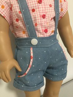 the doll is wearing overalls and shoes