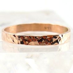 a close up of a gold ring on a white surface