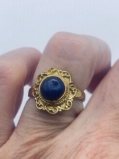 Blue lapis lazuli cocktail ring  Lovely vintage golden bronze setting Size 6.5 Our jeweler can custom re size this for a $20 fee.  All rings are shipped in a nice gift box.   Check out our over a THOUSAND great reviews Engraving is $4 per letter and is not always perfect depending on the piece. It can take a few days if the jeweler is busy. This is payable to Paypal Judithsltd@gmail.com Blue Brass Jewelry For Anniversary, Gold Vintage Rings For Gifts, Gold Vintage Rings For Gift, Vintage Gold Rings For Gifts, Antique Gold Sapphire Ring, Gold Sapphire Ring Gift, Unique Antique Finish Rings As Gift, Vintage Gold Sapphire Ring, Antique Finish Jewelry Ring As A Gift