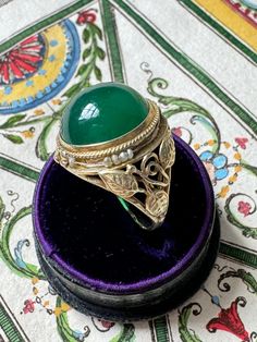 Weight: 5 grams Measurements: 18 mm north to south, cabochon 13.5 x 13.5 x 6.4 mm Markings: 14K Size: 5.5 Notes: missing seed pearls Formal Cabochon Chrysoprase Jewelry, Antique Yellow Gold Cabochon Emerald Ring, Antique Yellow Gold Emerald Cabochon Ring, Vintage Yellow Gold Cabochons As Gift, Vintage Yellow Gold Cabochons For Gift, Heirloom Green Opal Ring As Gift, Heirloom Green Opal Ring Gift, Heirloom Style Green Opal Ring Gift, Heirloom Green Oval Cabochon Rings