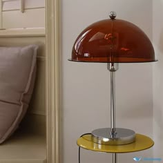 a table lamp sitting on top of a yellow shelf