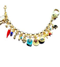 Colorful protective Evil Eye Charms and an Assortment of other Gold Vermeil Good Luck & protective charms bestow plenty of positive energy channeled unto this charm bracelet.  FOCAL EVIL EYE charm is bezeled in a Gold Vermeil oval setting with a beautiful GREEK KEY design surrounding its border & measures 15x10mm. 1 inch TURKISH COIN charm overlaid with 10 x 6 mm RED EVIL EYE charm  Adorable little HAMSA charm measures 15 x 10 mm   Beautiful 10 x 6 mm BLUE EVIL EYE overlaid on BLUE DRUZY STONE D Gold Bohemian Evil Eye Bracelet For Festival, Spiritual Bracelet Souvenir Jewelry, Festival Jewelry With Gold Dangling Charms, Gold Jewelry With Dangling Charms For Festival, Gold Festival Jewelry With Dangling Charms, Spiritual Souvenir Bracelet Jewelry, Gold Bohemian Evil Eye Bracelet, Bohemian Jewelry Bracelet With Charms, Spiritual Multicolor Charms Jewelry