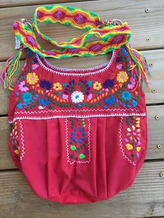 "**Small unlined bag** This is a beautiful embroidered bag handmade by Mexican Artisans With elegant multi-colored designs and patterns Each embroidered bag takes about 10 hours to make Straps are made with macrame technic The strap is long enough to wear as a simple over the shoulder or as a crossbody Every bag is unique, made by womwn artisans of San Gabriel Chilac, Puebla Excellent gift for any occasion Due to the hand made nature of this item the embroidered colors and patterns may vary **HA Festival Multicolor Embroidered Hobo Bag, Handmade Crossbody Hobo Bag For Festivals, Handmade Hippie Hobo Bag For Festivals, Bohemian Woven Bags For Festivals, Red Beach Bag With Tassels, Traditional Pink Summer Bags, Red Bohemian Shoulder Bag With Tassels, Bohemian Red Hobo Bag With Adjustable Strap, Red Bohemian Hobo Bag With Adjustable Strap