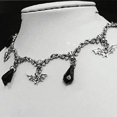 Add a touch of dark elegance to any outfit with our Gothic Victorian Pendant Choker Necklace. The intricate design and choker style make this necklace a unique and stylish addition to your jewelry collection. Stand out from the crowd with this must-have accessory! Gothic Dangle Necklaces For Parties, Gothic Metal Dangle Necklaces, Halloween Choker Necklace With Chain, Elegant Metal Dangle Choker, Halloween Silver Choker Necklace, Gothic Pendant Necklace For Party, Gothic Necklaces With Adjustable Chain, Formal Metal Choker With Clavicle Chain, Formal Gothic Metal Choker