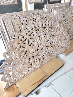 an intricately carved wooden panel is shown in the process of being cut into pieces